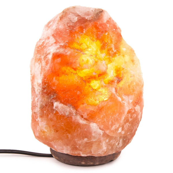 Himalayan salt lamp with a warm glow on a white background