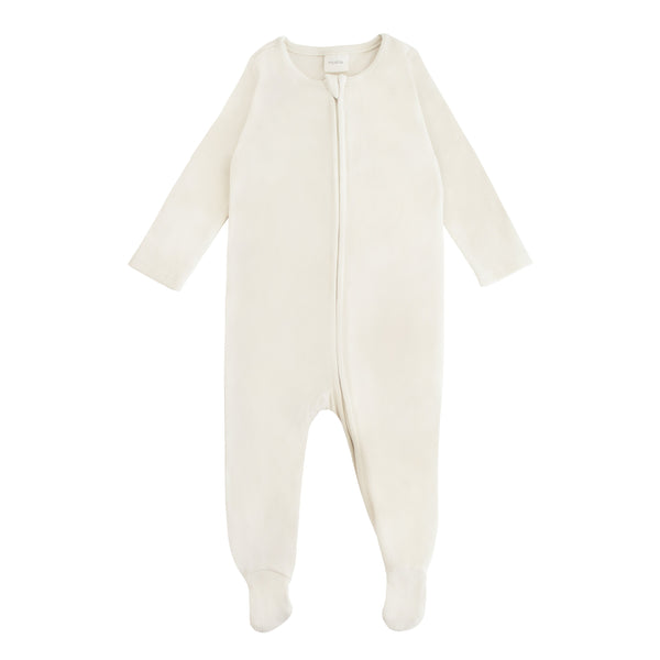 The mushie Zipper Pajama is a cream-colored, long-sleeve onesie with covered feet and a front zipper—perfect cozy footed pajamas or comfy organic cotton sleepwear for babies.